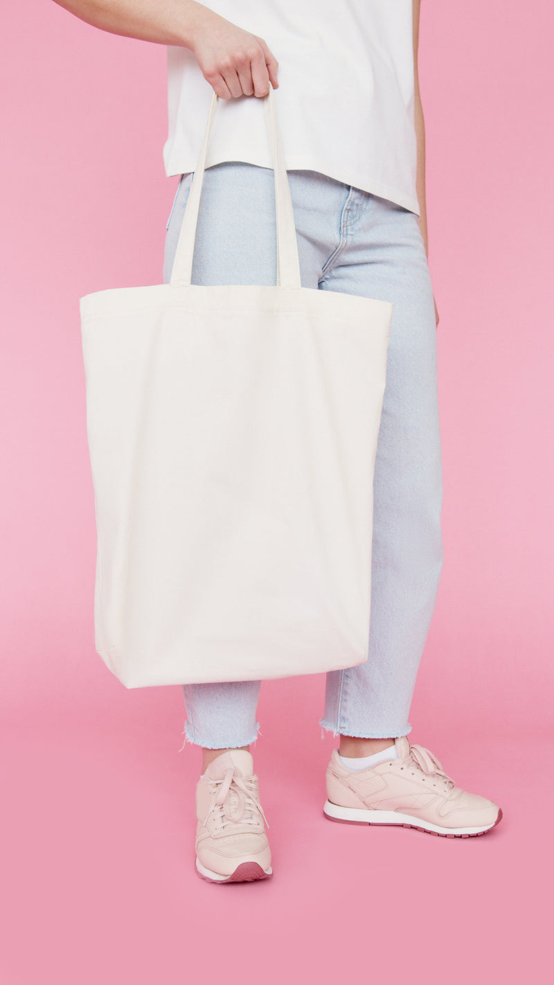 Trendy tote bag carried by young woman